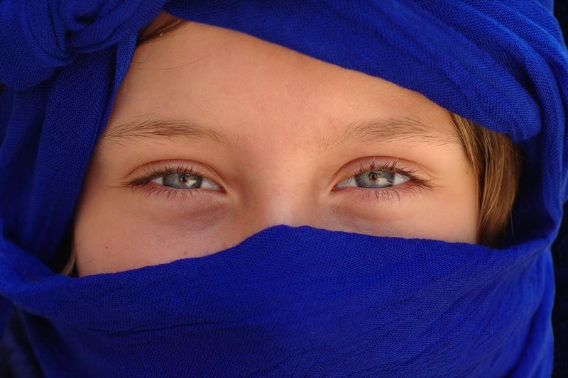 Berber women have heavy silver jewellery, face tattoos and will be selling their hand-woven carpets.