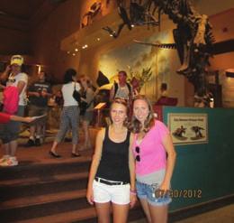 legacy. Sarah and Laura stand in front of a T-rex at the Smithsonian National Museum of Natural History.