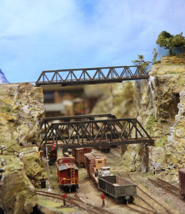 Here is a busy section of the layout with track and siding, a rock cut with a bridge just above the tracks - in fact two bridges, and a bridge for the narrow gauge line above those.
