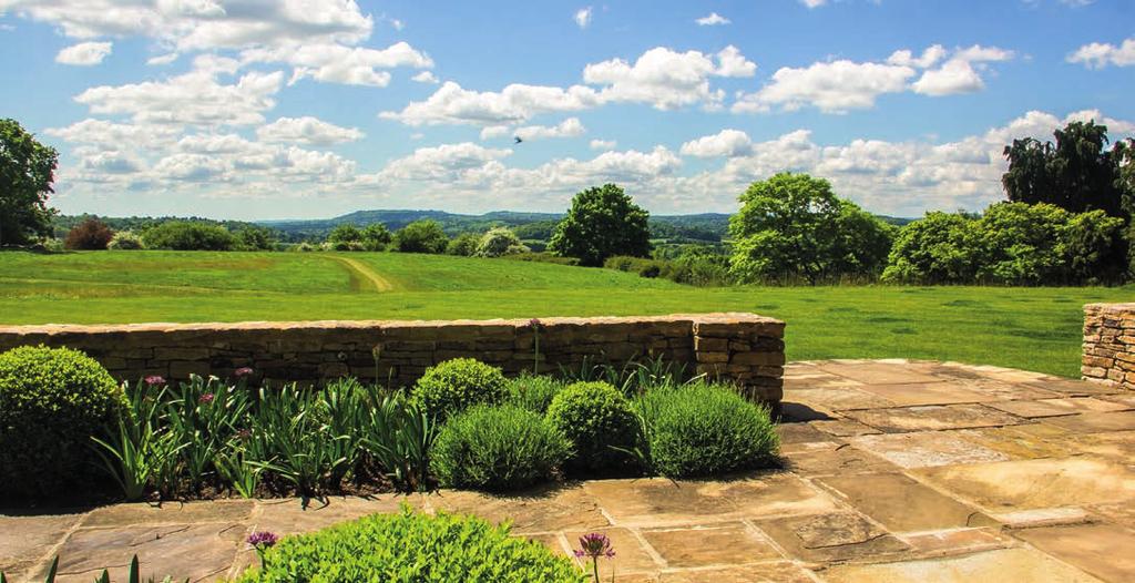Outside The gardens flow gently away from the house and terrace and are south facing, offering incredible far reaching views towards the Surrey Hills.