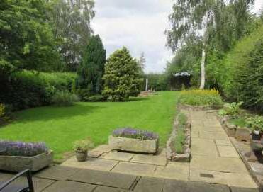 plot, together with mature Silver Birch and conifer trees and a hedged screen for privacy.