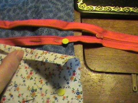 Pin the bottom half of the zipper to the pocket. I show it pinned to the fabric here just for placement idea.