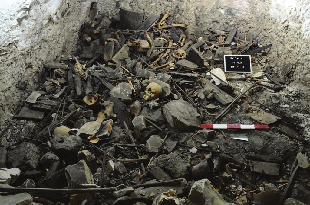 Above: east side of room M at the moment of discovery, showing a pile of coffin pieces, fragments of wood and human remains. Photo: Gianluca Miniaci. Below: foot-end with drawn feet.
