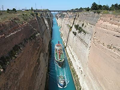 Ancient Corinth: We shall pass over and stop at the Isthmus Canal. A breath-taking example of human achievement. It is a spectacular sight. A canal cut straight down through deep limestone.