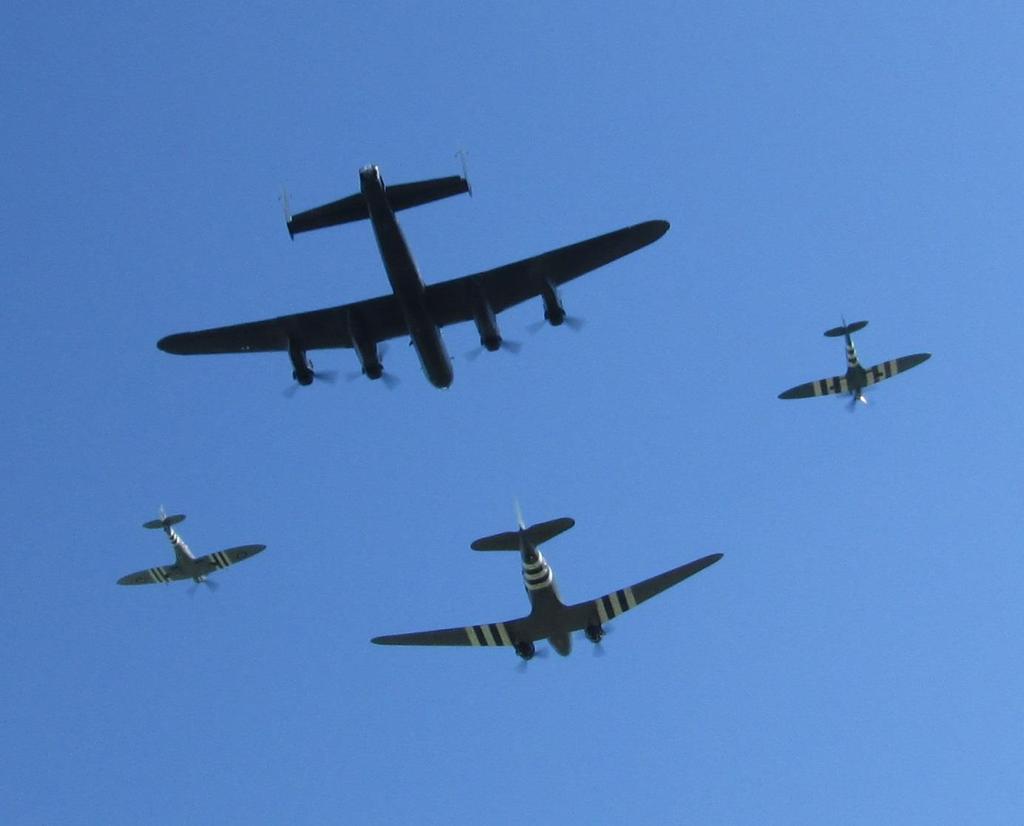 A Lancaster Bomber lead by a Dakota with a