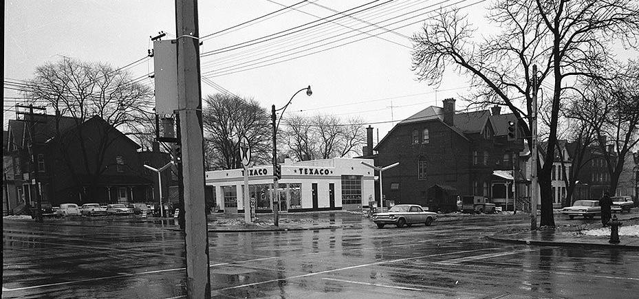 8. Archival Photograph, Southeast Corner of Gerrard Street East and Sherbourne Street, 1960s: after the house form buildings adjoining the corner were