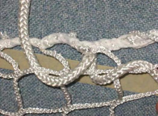 Alternating sides of the harness, continue moving inward to the next strand (as illustrated in Figure 18) until all strands are secured to the netting with a bowline tied tightly. Note.