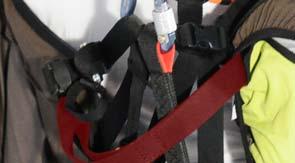 When connecting the reserve parachute to the harness, ensure that the parachute bridle passes outside the harness' main attachment strap and then to the karabiner.