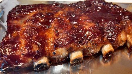Put the bag in a large oven roasting pan and arrange the ribs inside in a single layer, then add the water.