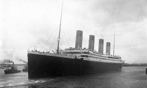 The man in the foreground is holding a camera and is watching the departure of Titanic on board the same ship as the photographer who recorded this view.