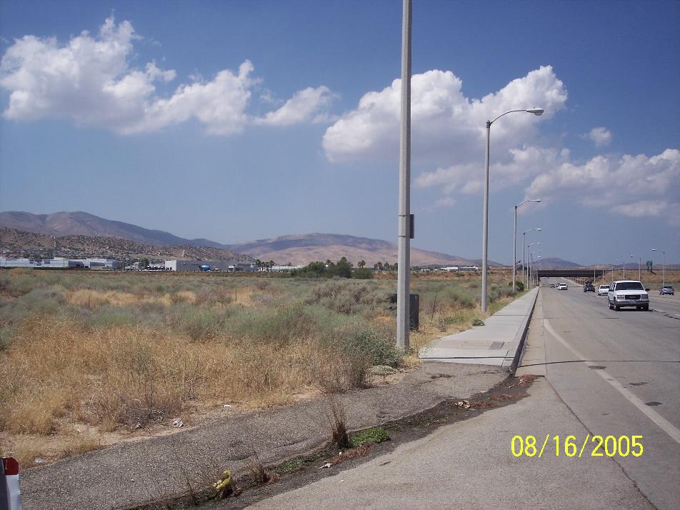 (Buildings in view are Palmdale Auto Mall) Corner of the property looking South across P-8. Northeast corner of the property looking South toward Palmdale Blvd. Dirt street is Division.