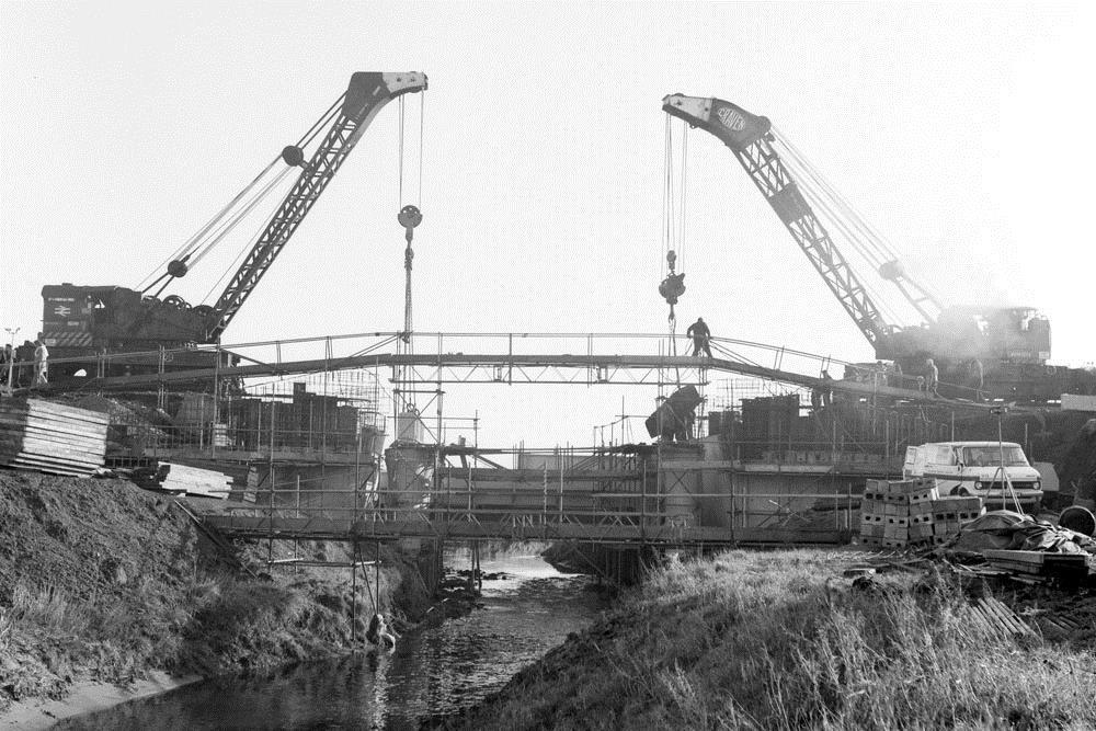 Steam Crane Activity at Maghull In this view looking south the two steam cranes at seen at work on the replacement of bridge No. 18 on Sunday 13 January 1980.