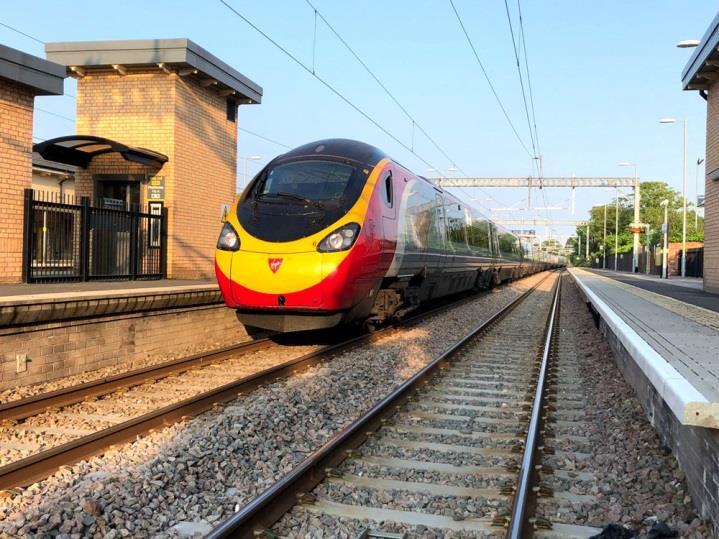 [7] Left: On Monday 28 May 2018 Virgin Trains Pendolino number 390 127 is seen passing through Huyton on 5P37 an empty stock working from Edge Hill to Preston.